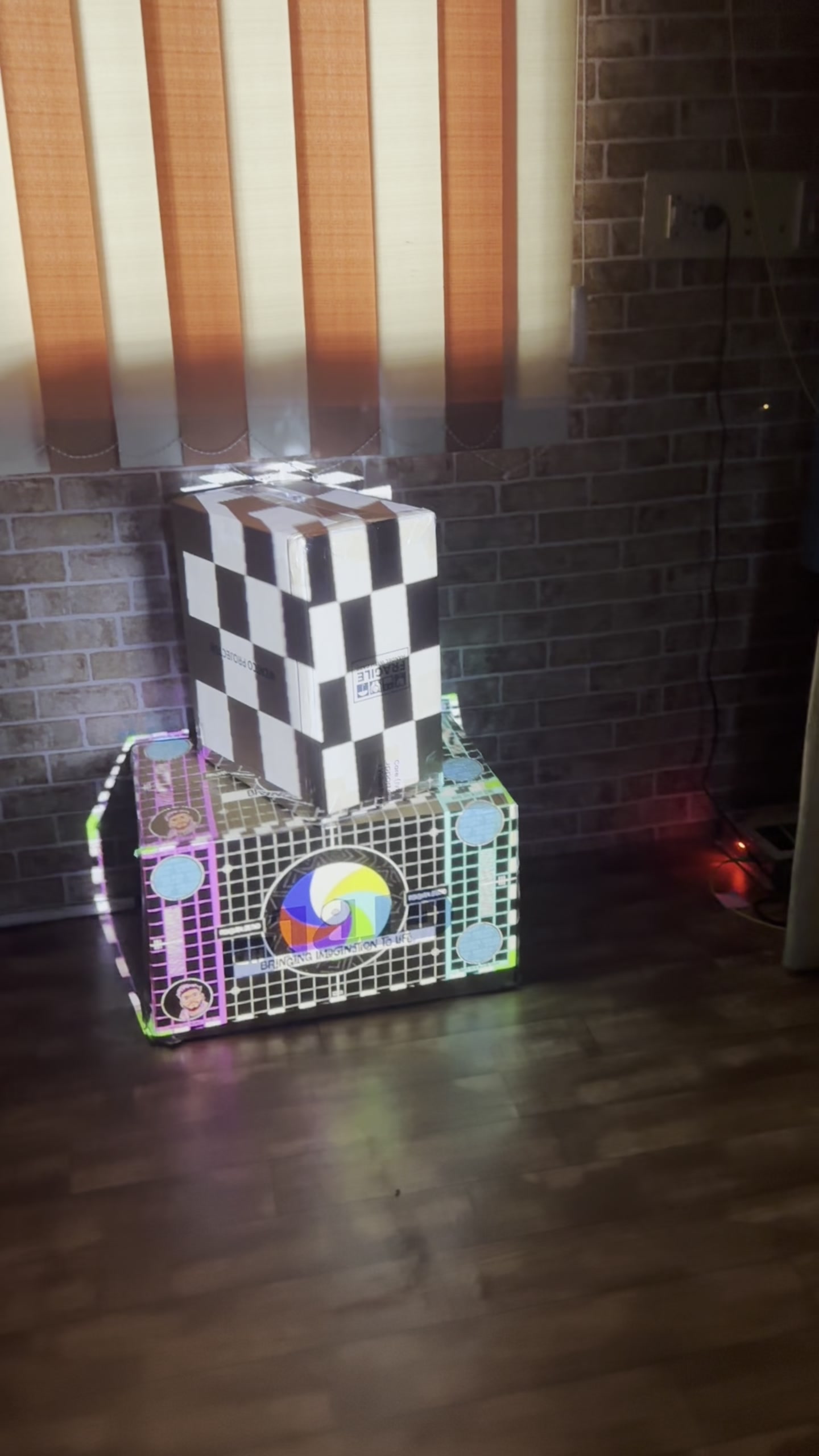 Studio projection mapping test: graphics mapped onto two stacked boxes, following every edge and face